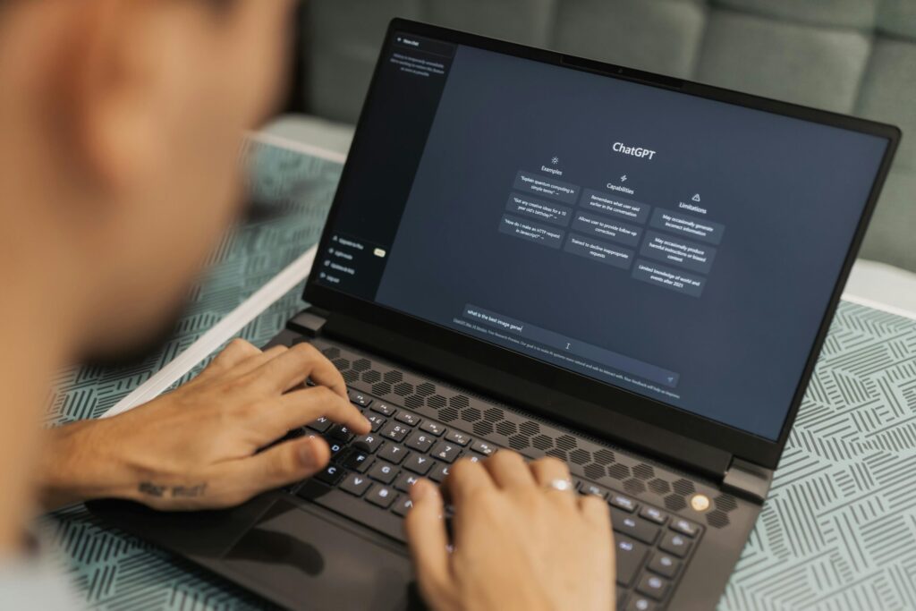 Man typing on laptop with ChatGPT on the screen.
Public Domain, Matheus Bertelli