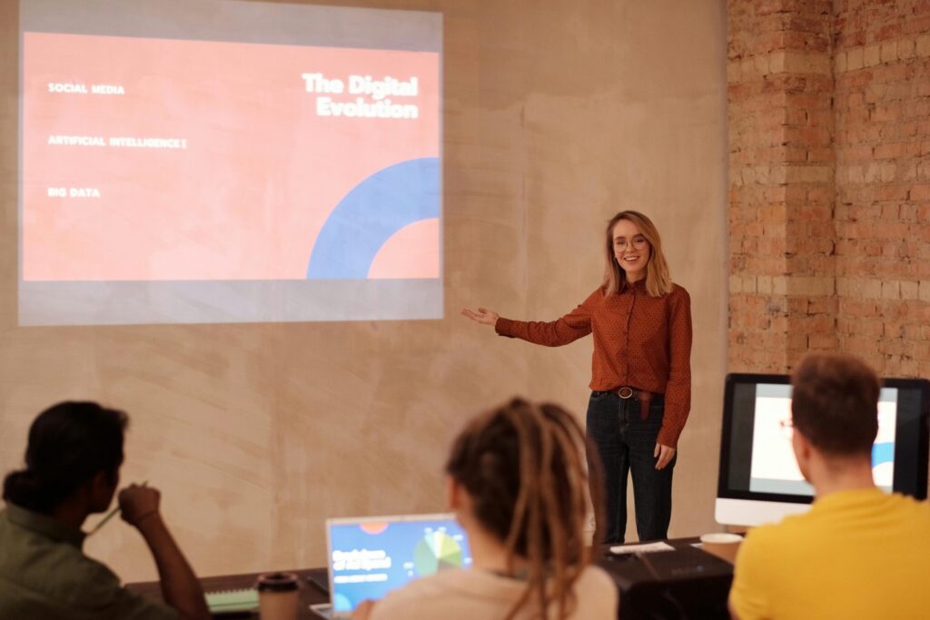 Woman teaching in front of projected slide on digital evolution while students look on.
public domain mikael blomkvist
